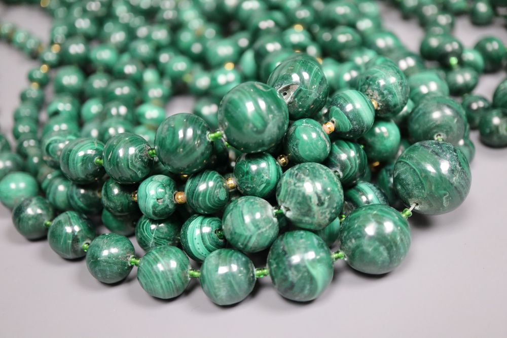 Ten assorted single strand malachite bead necklaces, two with gilt metal spacers, largest 64cm.